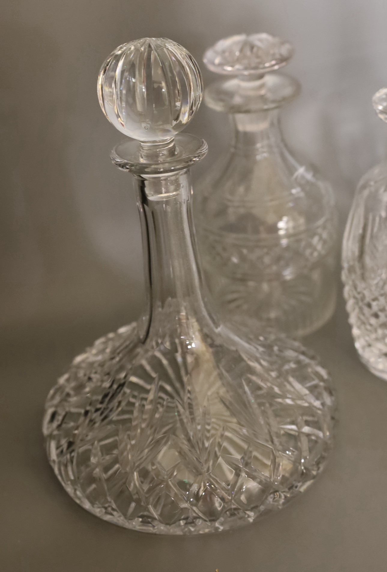 Two Waterford glass decanters, and three other decanters